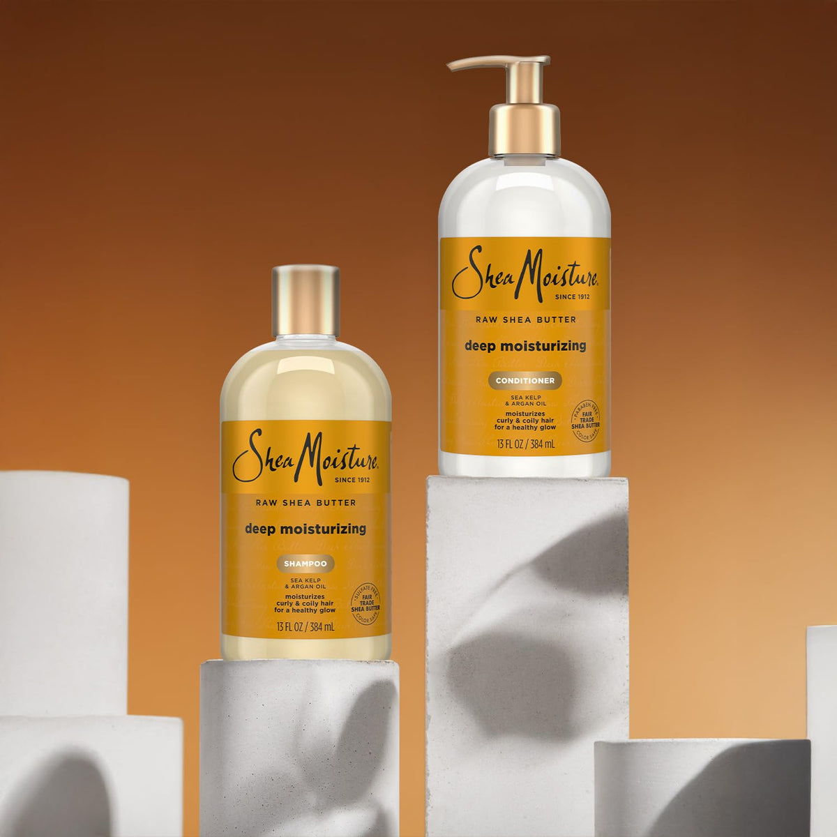 SheaMoisture being applied in shower to wet curls for moisturized results