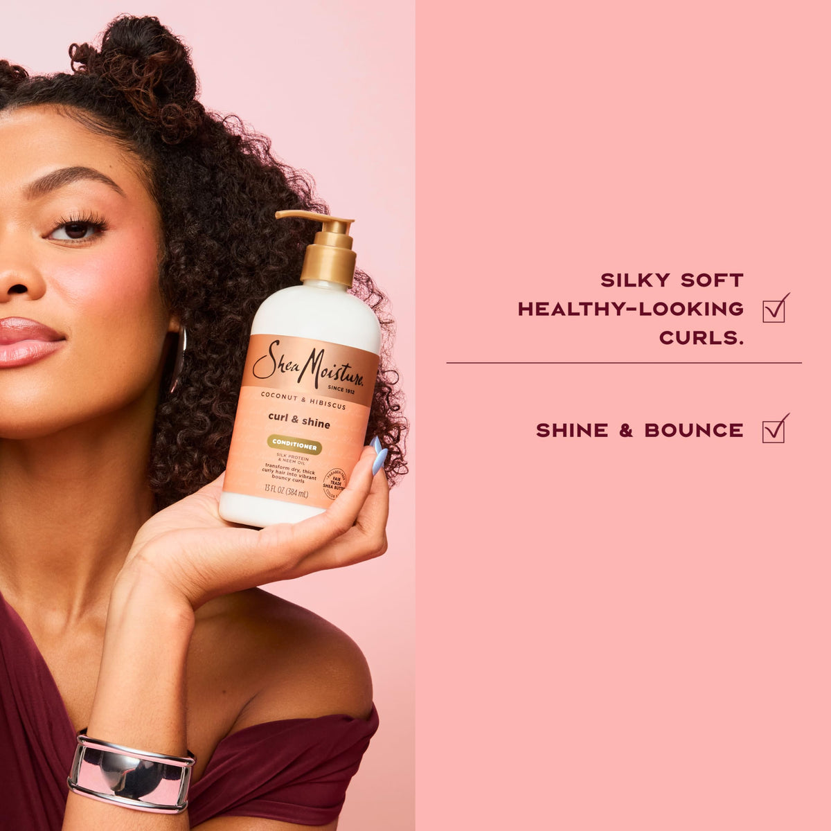 SheaMoisture conditioner being applied to wet curly hair for effortless detangling