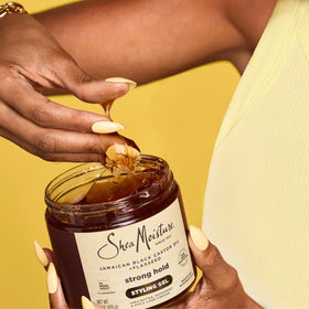 SheaMoisture ingredient label close-up showing castor oil, shea butter benefits
