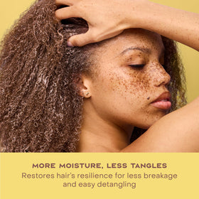 Shea Moisture bottle on a bathroom shelf in a self-care setup