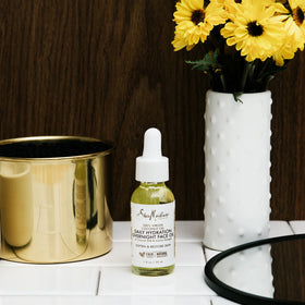 SheaMoisture open bottle with oil dropper showing smooth absorbent texture