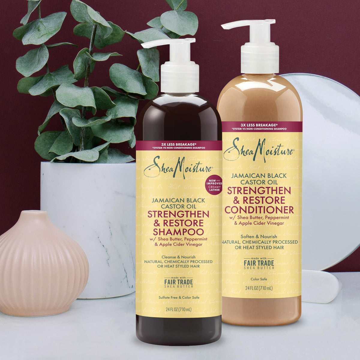 Shea Moisture 24oz bottles held in hand to show true scale