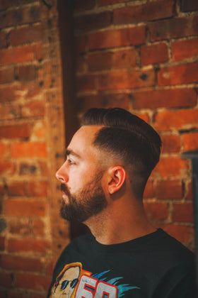 Shear Revival styled model in barbershop setting demonstrating textured, matte hairstyle benefits
