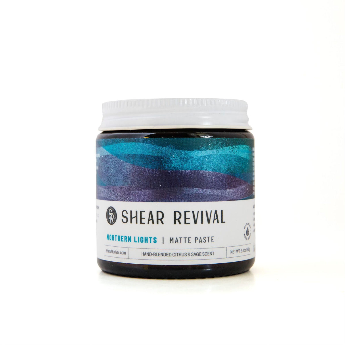 Shear Revival jar front view showing label and amber glass, conveys premium travel-friendly packaging