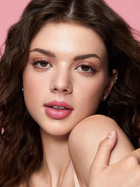 SHEGLAM model applying balm demonstrating natural, hydrating flush