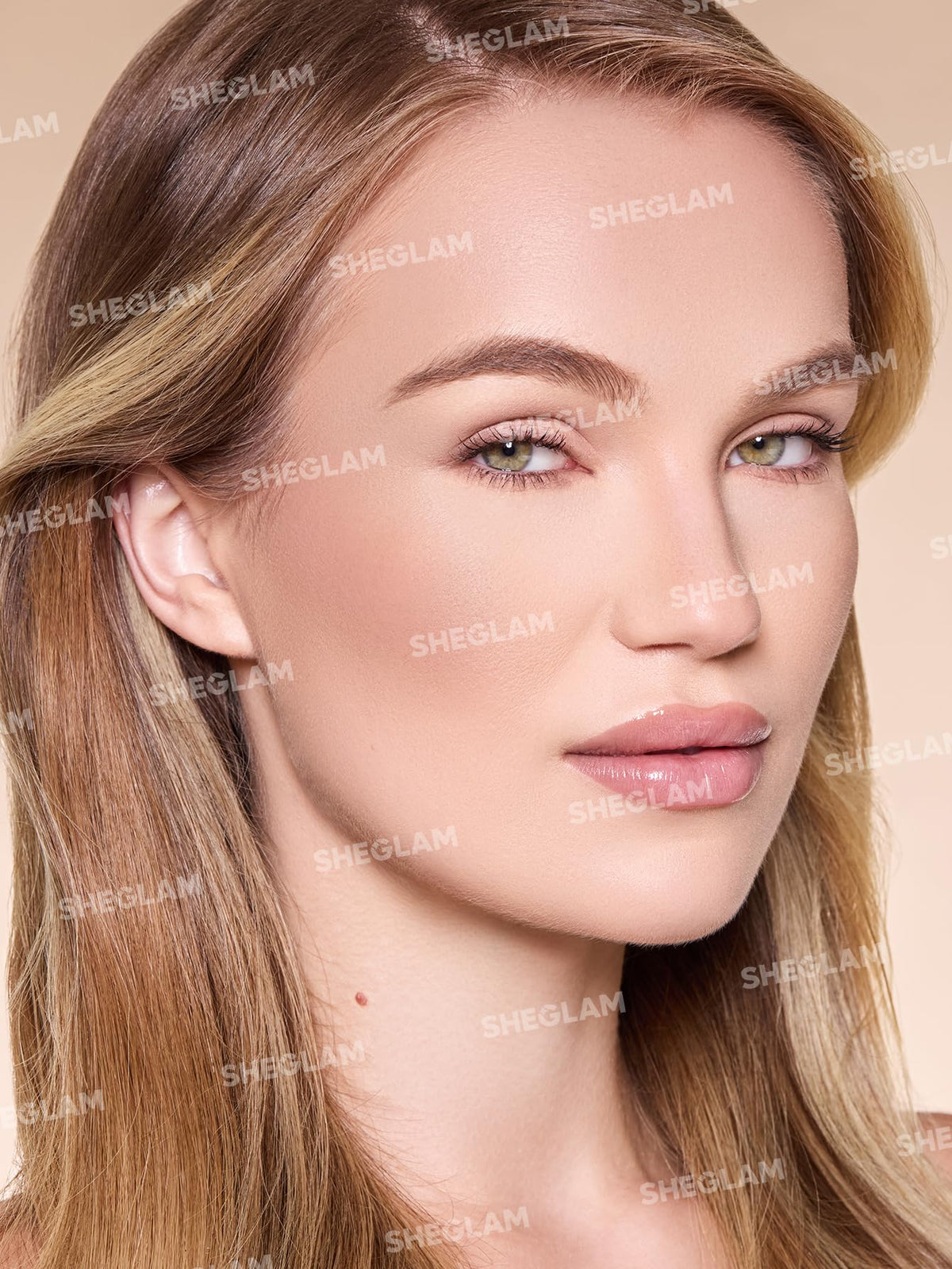 SHEGLAM applied under cheekbone with sponge, creates sculpted definition