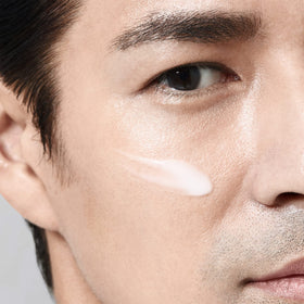 Shiseido Men bottle beside ruler showing 100 mL size and travel-friendly benefit