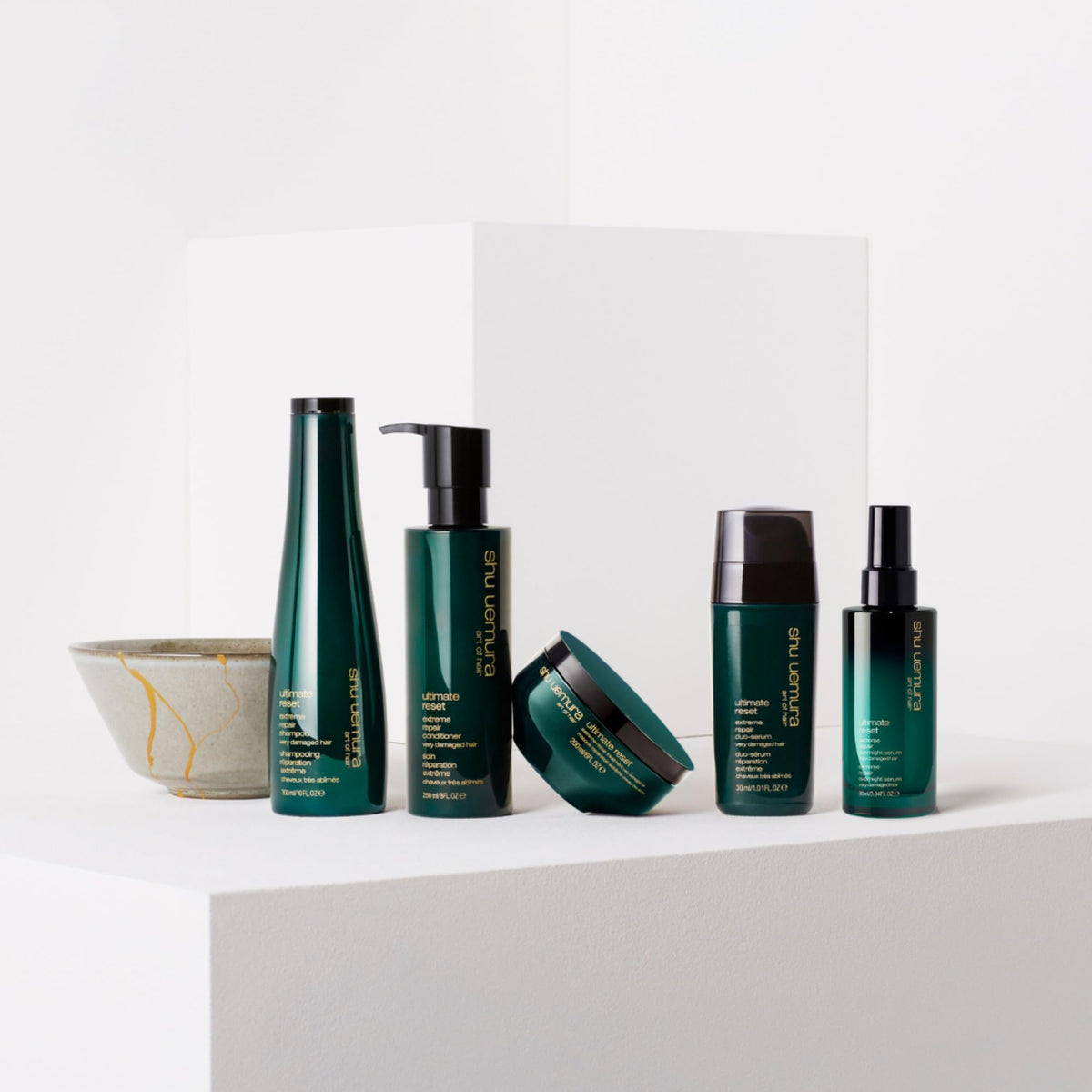 shu uemura art of hair bottle on bathroom shelf in lifestyle scene suggesting daily use