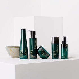 shu uemura art of hair bottle on bathroom shelf in lifestyle scene suggesting daily use