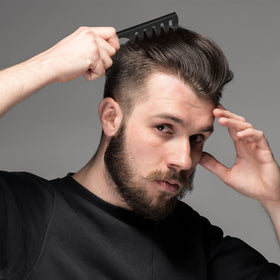 Sieral comb gliding through curly hair to detangle without pulling