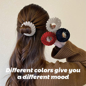 Sizobi clip securing a top knot hairstyle for fast, damage-free styling on the go