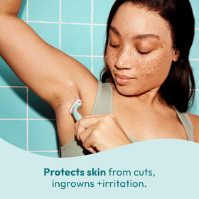Skintimate bottle in hand showing 7.3oz scale and travel-friendly size