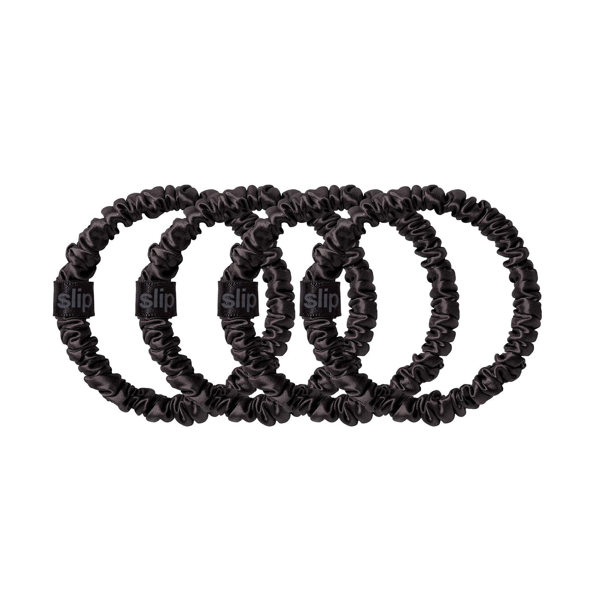 Slip packaging set of four black silk scrunchies indicating gift-ready convenience