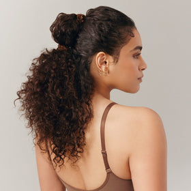 SLIP scrunchie worn on wrist as accessory, doubles as stylish on-the-go storage