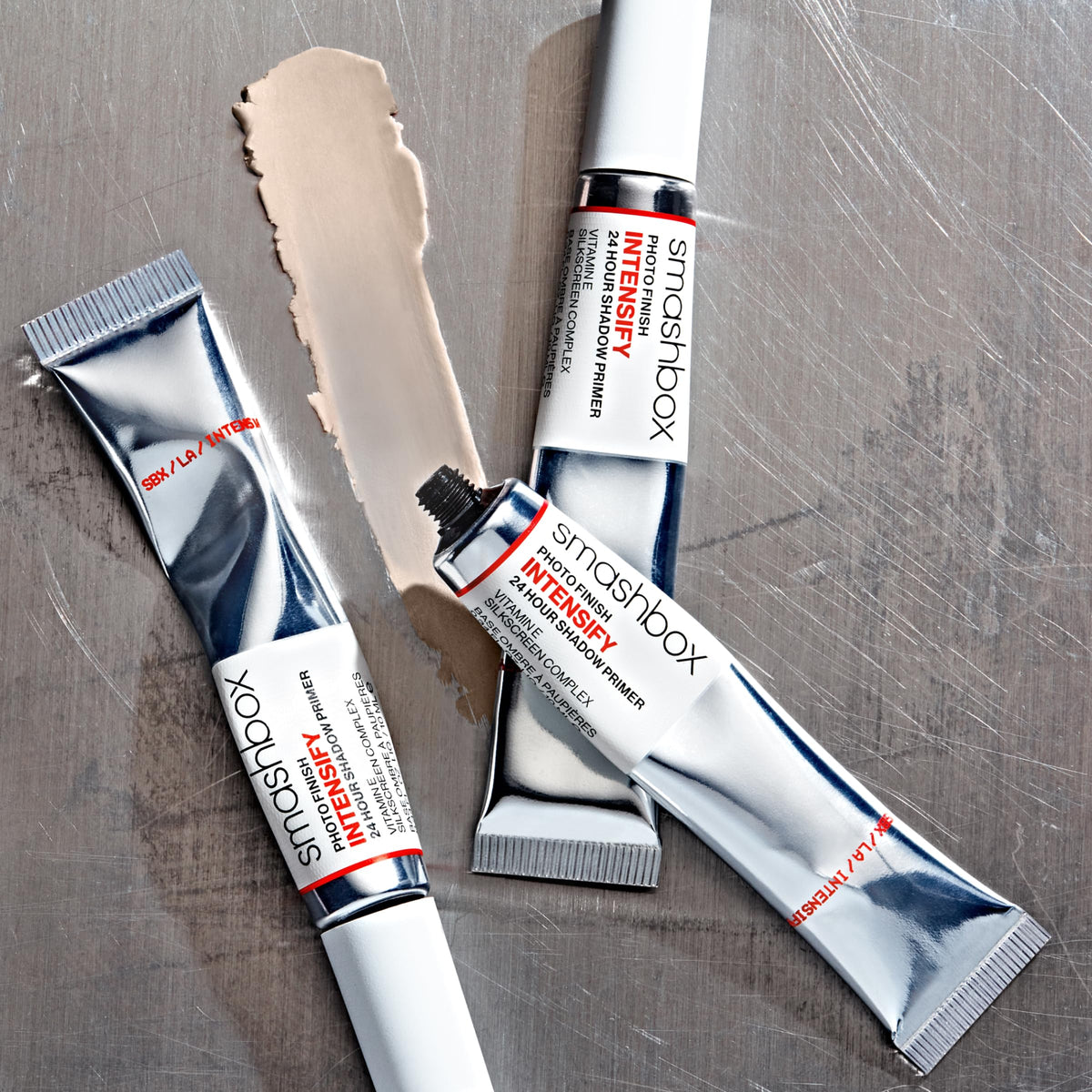Smashbox lifestyle shot of model applying primer showing lasting makeup benefit