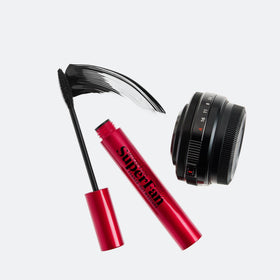Smashbox next to makeup essentials in a vanity scene for everyday beauty use