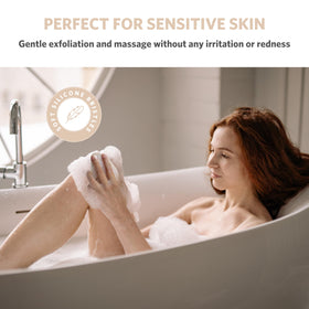 Sndyi scrubber beside hand and soap bar showing compact size and coverage