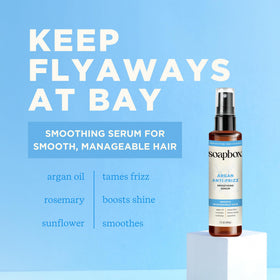 Soapbox serum being smoothed into dry hair to tame flyaways and boost shine