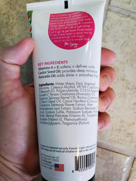 SoCozy child applying cream demonstrating defined, frizz-controlled curls