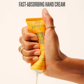 Sol de Janeiro applying hand cream to skin for instant softness