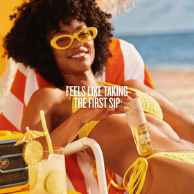 Sol de Janeiro bottle in hand to illustrate compact travel-friendly size