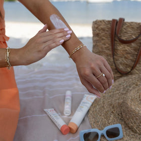 Solara Suncare being applied on arm showing moisturizing protection benefit
