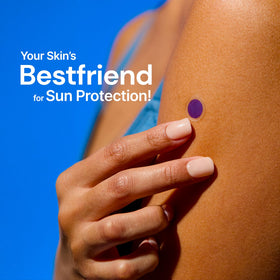SPOTMYUV sticker applied on arm beside sunscreen bottle, simplifies reapplication decisions