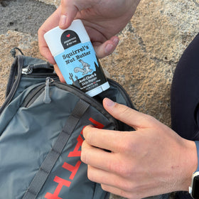 Squirrel's Nut Butter stick in a runner's pocket demonstrating portable, quick access