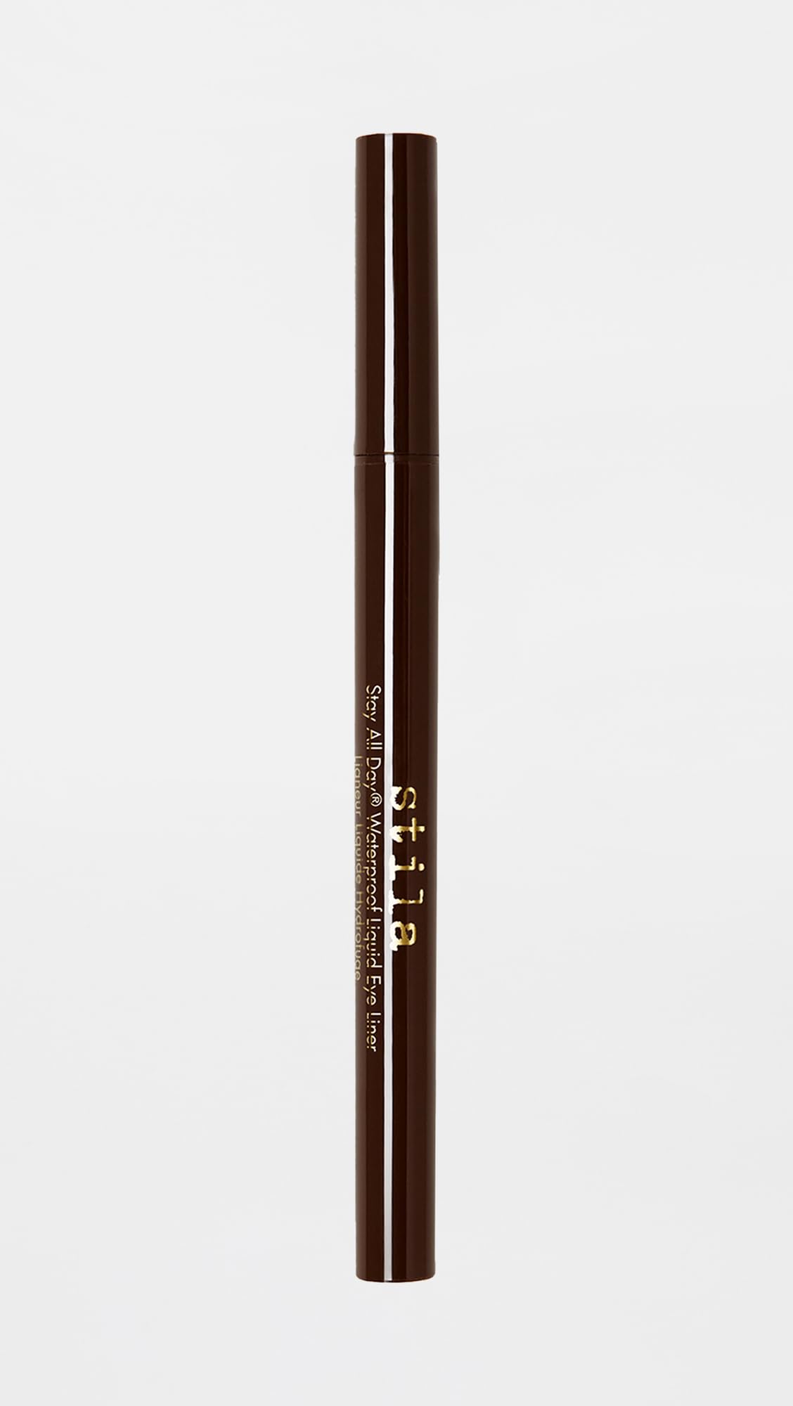 stila size and scale next to hand showing compact, travel-friendly design