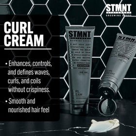 STMNT curl cream in hand being applied to damp hair to enhance curl and moisture