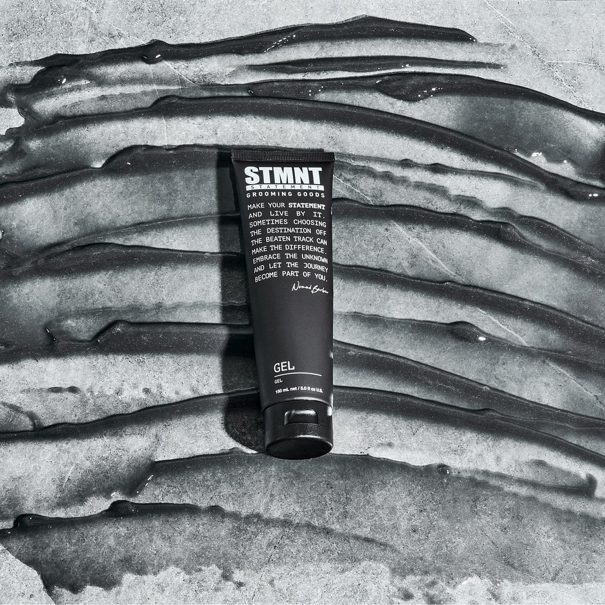 STMNT gel on hands being applied to hair, demonstrating controlled distribution