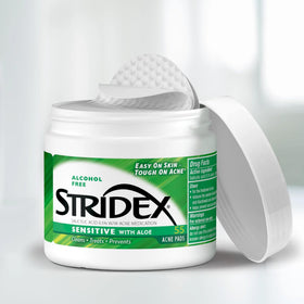 Close-up of textured Stridex pad surface showing fibers and gentle exfoliation - effective cleansing