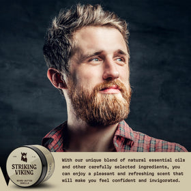 Bearded man applying Striking Viking butter for softer manageable facial hair