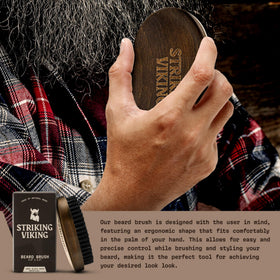 Striking Viking in-use brushing a medium beard for smoother, well-groomed facial hair