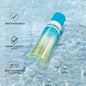 St.Tropez size comparison in hand to show travel-friendly bottle