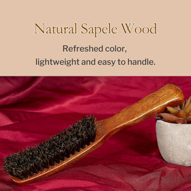 STYLEMATE brush held in hand to show scale and lightweight ergonomic benefit