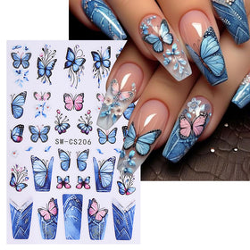 STZPRONAIL hands applying a floral sticker to a polished nail for neat DIY manicure