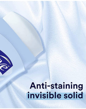 Suave beside a hand to show compact 2.6 oz (76 ml) travel size