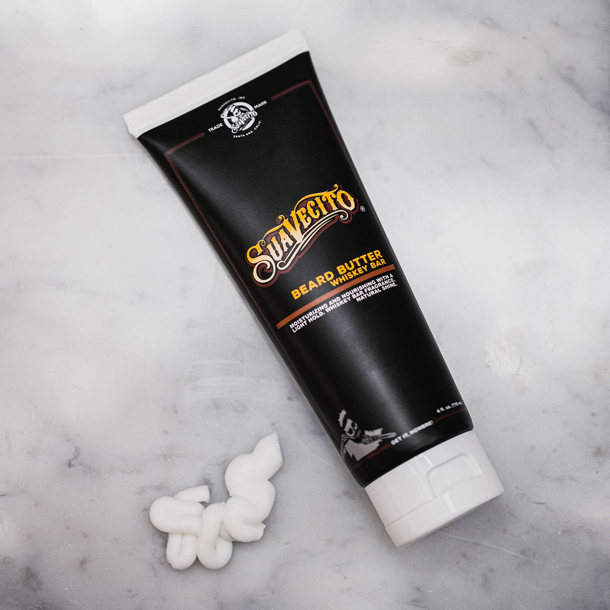 Suavecito jar on bar counter with whiskey glass conveying warm fragrance