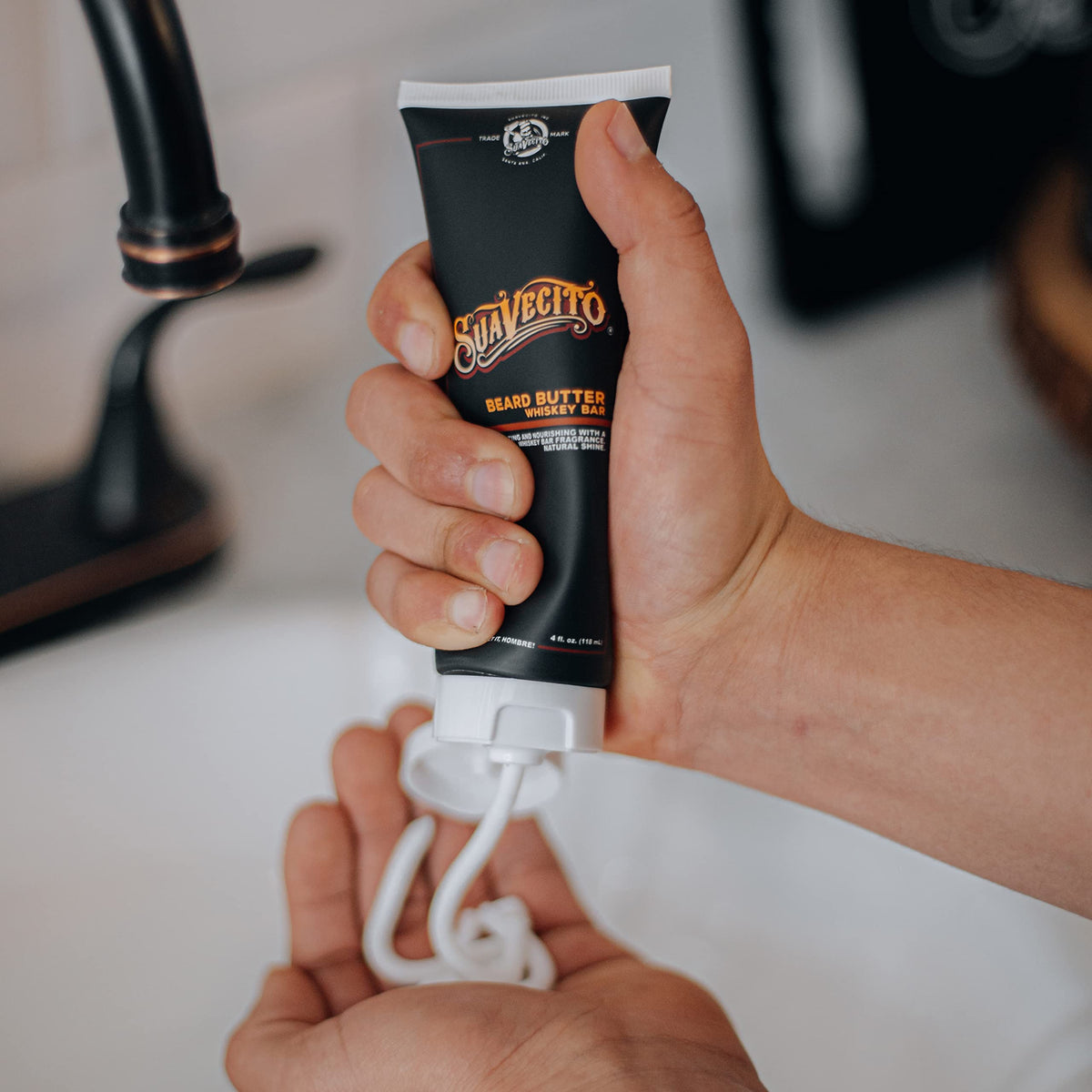 Suavecito jar next to hand displaying 4 oz scale for accurate sizing