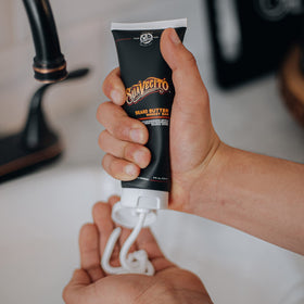 Suavecito jar next to hand displaying 4 oz scale for accurate sizing