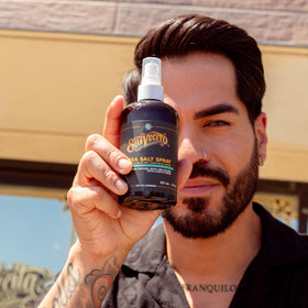 Suavecito lifestyle shot on beach-styled hair for relaxed, lived-in look