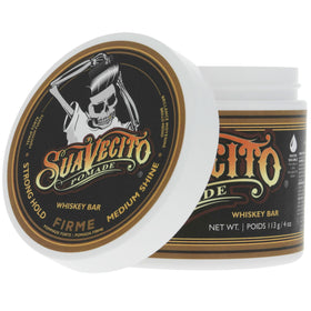 Suavecito Whiskey Bar in barbershop setting showing community roots and professional finish