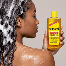 SULFUR8 shampoo bottle in hand to show product size and easy dispensing