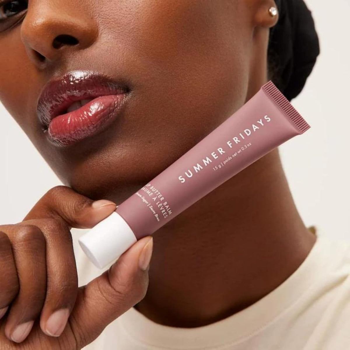 Summer Fridays balm applied on lips in lifestyle shot for instant shine benefit