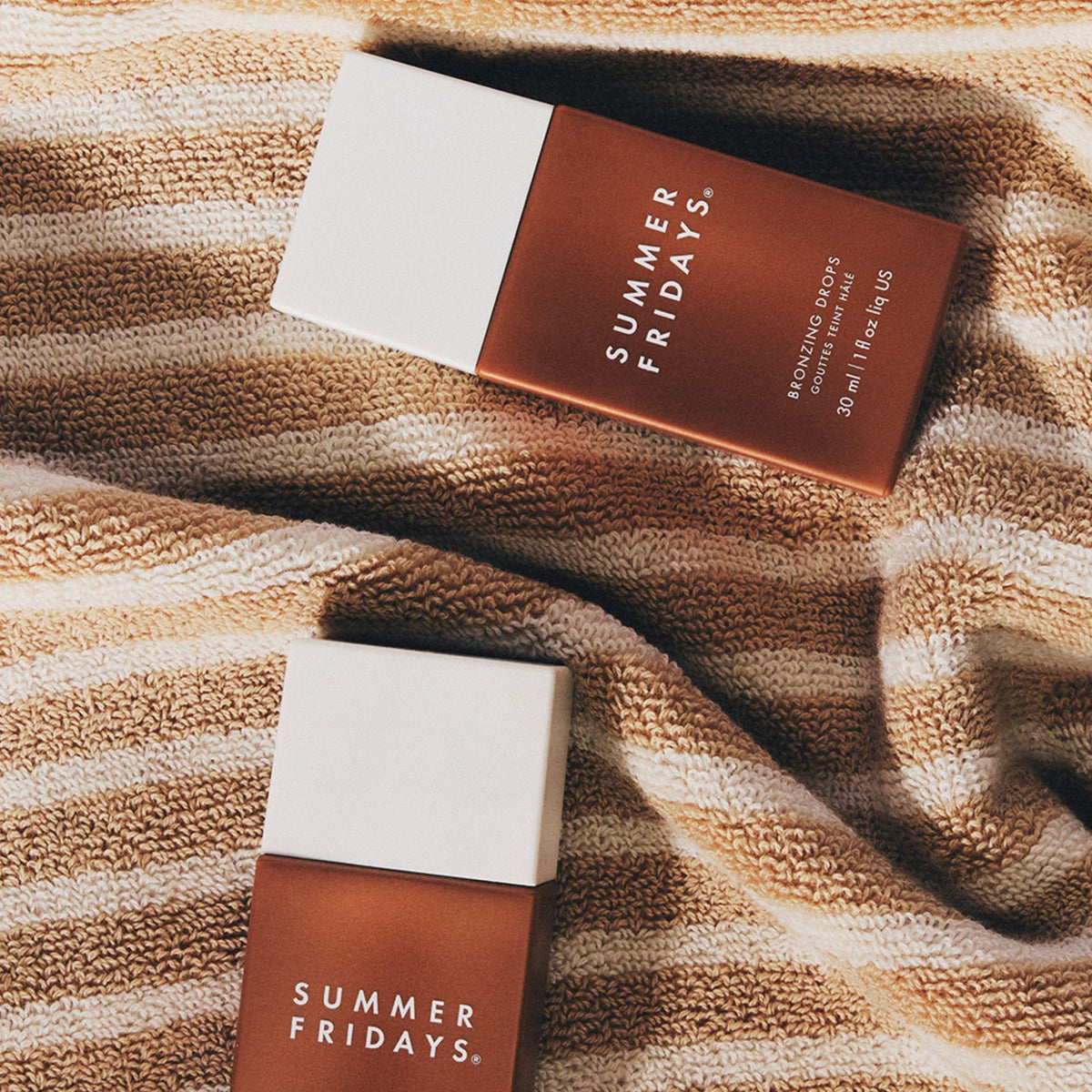 Summer Fridays bottle styled on vanity with towel, evokes effortless routine and luminous benefit