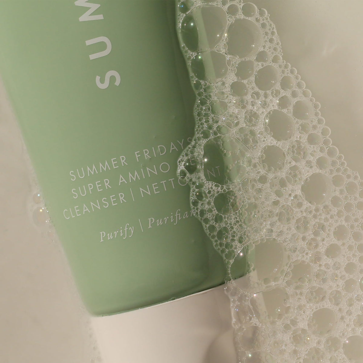 Summer Fridays cleanser poured into palm highlighting silky feel and makeup removal capability