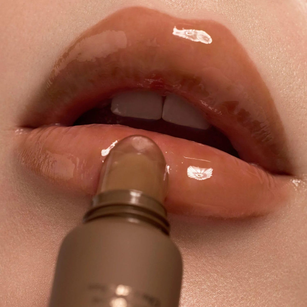 Summer Fridays lipstick layering image showing balm used under lipstick for added comfort