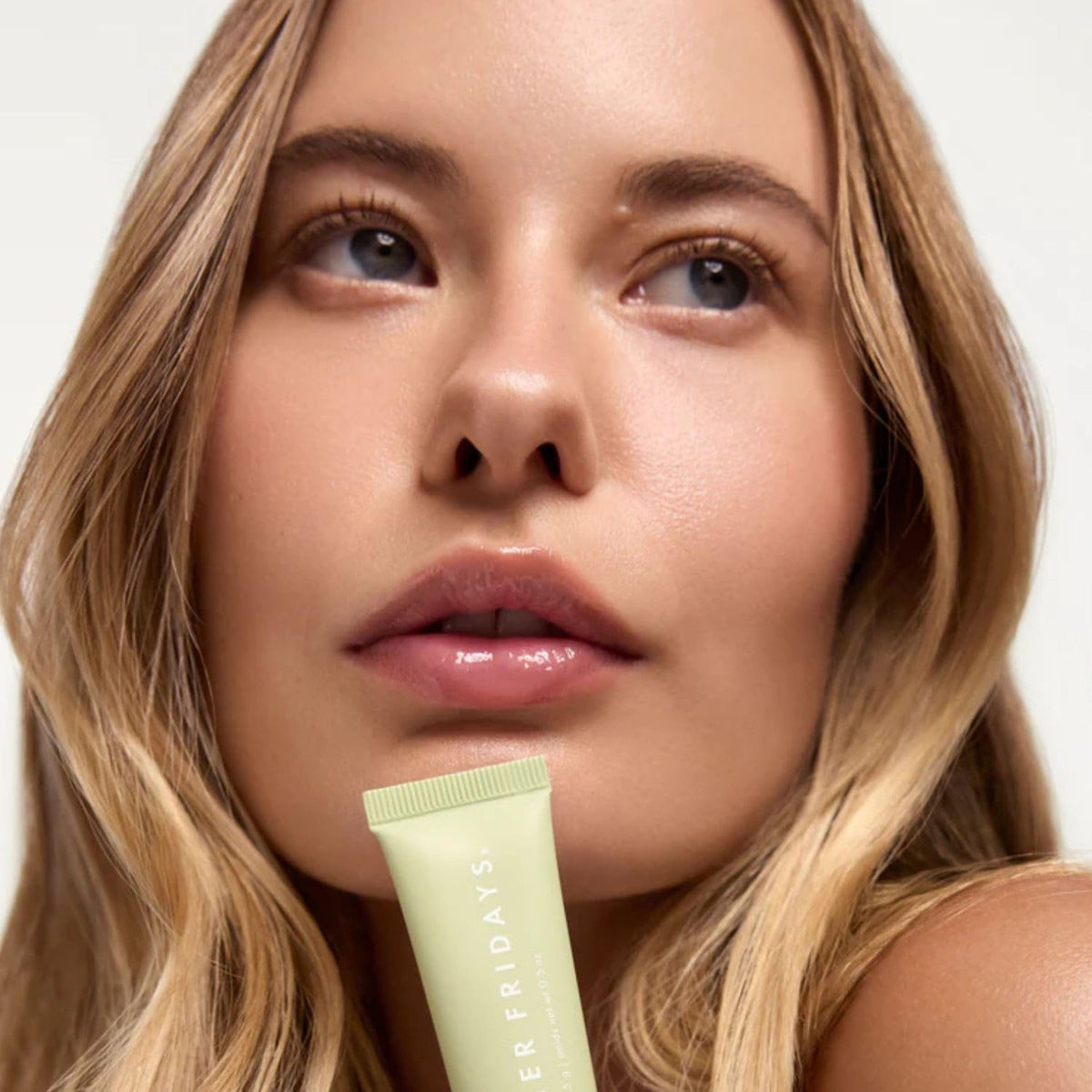 Summer Fridays over lipstick image showing clear gloss topcoat for luminous finish