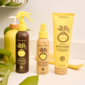 Sun Bum being applied to towel-dried hair demonstrating frizz control and natural texture